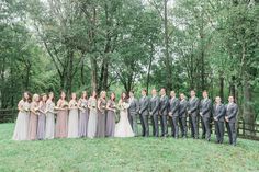 a group of people standing next to each other in front of trees