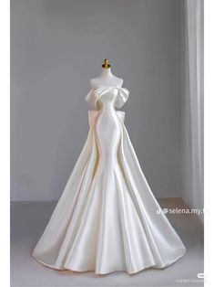 a white wedding dress on a mannequin