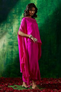 Hot pink silk asymmetric cape with bandhani print. Comes with a draped skirt.
Components: 2
Pattern: Printed
Type Of Work: Bandhani
Neckline: Asymmetric Neck
Sleeve Type: Flared Sleeves
Fabric: Silk
Color: Pink
Other Details: 
Tassel detailing on cape
Occasion: Sangeet - Aza Fashions Silk Palazzo Set With Traditional Drape For Evening, Silk Palazzo Set For Evening With Traditional Drape, Evening Silk Sharara With Traditional Drape, Silk Sharara For Evening With Traditional Drape, Silk Sharara For Evening Wear, Silk Dupatta For Evening, Traditional Drape Kaftan With Gota Work For Parties, Party Kaftan With Gota Work And Traditional Drape, Silk Draped Dupatta