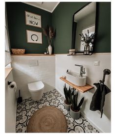 a white toilet sitting next to a sink in a bathroom