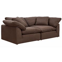 a large brown couch with pillows on it's back and two sides facing each other