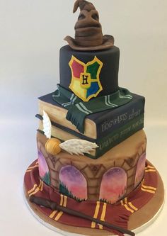 a cake made to look like a hog potter's hat and books