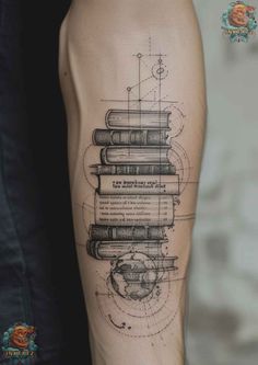 a person with a tattoo on their arm that has books stacked on top of each other