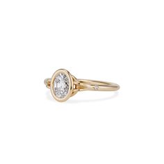 a gold ring with a white diamond in the center