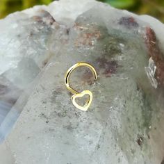 "Nose ring stud, 14K solid yellow gold heart. Available in 20 or 18 gauge. Available as a nose ring or cartilage earring. Nose ring - \"L\" post, screw back right or screw back left post. Cartilage earring - 11mm post with GF butterfly and silicone backings. Heart size: 3.6mm X 4mm The perfect gift for you or your loved ones. Follow us on: Instagram @sampsonjewelry Facebook @sampsonjewelry Pinterest @sampsonjewelry Tweet on Twitter @sampsonjewelry To save for later, click Add Item to Favorite. W Nickel Free Yellow Gold Wedding Ring, Dainty Pierced Rings For Gifts, Hypoallergenic Gold Heart Ring As Gift, Dainty Pierced Rings As Gifts, Yellow Gold Internally Threaded Rings For Gift, Tiny Gold Heart Ring For Wedding, Gold Internally Threaded Ring As Gift, Ring Gold Design, Nose Ring Designs