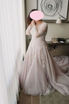 a woman in a wedding dress looking out the window with a pink bubble over her head