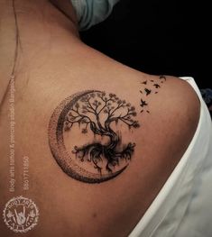 a woman with a tree tattoo on her back