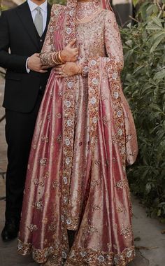 the bride and groom are posing for a photo