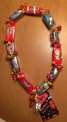 a candy bar necklace on top of a wooden table