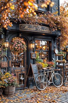 an old fashioned bicycle is parked in front of a building with autumn leaves on the ground