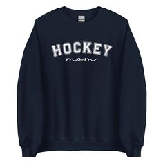 Mom: The real MVP behind every slapshot. Crafted from a premium cotton-polyester blend, this hockey-inspired sweatshirt delivers unbeatable comfort and style. Whether you're cheering rinkside, lounging at home after a big game, or layering up for chilly practice mornings, it’s the ultimate go-to. Designed with a versat Hockey Sweatshirts, Wine Wall Art, Hockey Mom, Jeans Leggings, Mom Sweatshirt, Hockey Players, Zip Pouch, Big Game, Stay Cozy