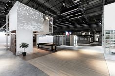 the interior of an office building with white walls and wood flooring is lit by overhead lighting