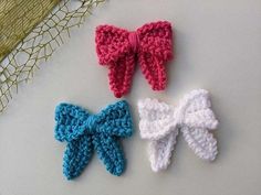 three crocheted bows sitting on top of a table