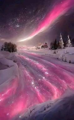 the sky is filled with pink and purple lights in this snowy landscape, as well as trees