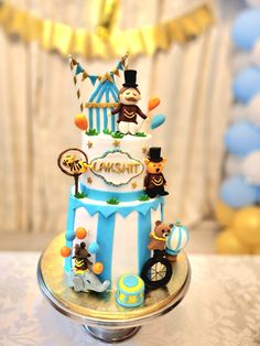 a three tiered cake decorated with circus animals