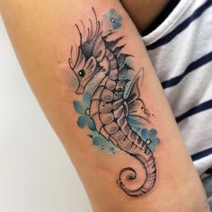 a sea horse tattoo on the arm