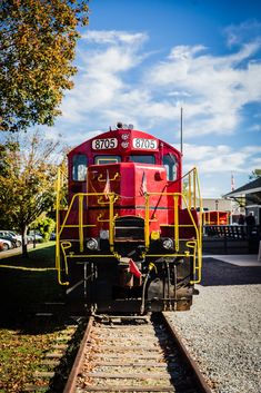 a red train engine sitting on the tracks