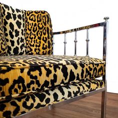 a leopard print couch sitting on top of a wooden floor