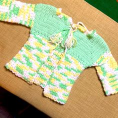 A Beautiful, Early 80s Hand Crocheted Baby Sweater. Gorgeous Craftsmanship And Essentially Bnwot Condition! Beautiful, Gender Neutral Color Palette Of Pastels With Lime Green, Yellow Accenting White. Front Tie Closure With Tassels. A Beautiful And Unique Piece To Add To Your Little Bundle Of Joys Wardrobe! Estimating It To Be A 12-18 Month. Measurements: Shoulders: 12” Sleeves: 6” Length: 12” Width: 9” Spring Cotton Sweater For Playtime, White Spring Sweater For Playtime, White Casual Spring Sweater For Playtime, Fitted Yellow Tops For Playtime, Playful Yellow Sweater For Spring, Vintage Style Tops For Playtime In Spring, Vintage Tops For Playtime In Spring, Crochet 80s Sweater, Vintage Crochet Baby Sweater