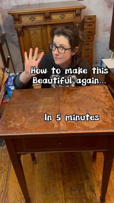 a woman sitting at a wooden table with her hand up in the air, saying how to make this beautiful again in 5 minutes