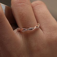 a woman's hand with a diamond ring on it