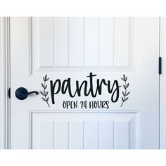 pantry open 24 hours decal on the door to a kitchen with white doors and black handles