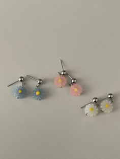 Fun, quirky, and full of personality - these acrylic resin dangle earrings feature charming daisy flowers and come in your choice of gold or silver earring posts. Choose your preferred flower dangle color to add a touch of playfulness to any outfit.- Stainless steel, Acrylic Resin- Daisy: 10x10mm- Stud ball: 4.8mm Trendy Silver Flower Earrings, Daisy Flower Earrings For Spring, Trendy Flower Earrings, Trendy Flower Shaped Earrings, Spring Daisy Flower Earrings, Trendy Nickel-free Flower Earrings, Trendy Hypoallergenic Flower Earrings For Spring, Cute Silver Flower Earrings, White Daisy Flower Earrings For Spring