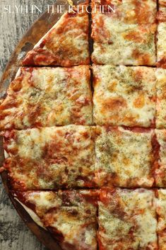 the pizza is cut into eight squares and ready to be eaten with cheese on top