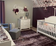 a baby's room is decorated in purple and gray colors with floral wallpaper