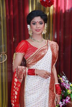 a woman in a white and red sari