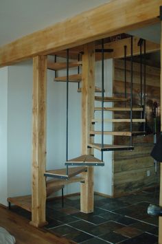 a room that has some stairs inside of it with wood and metal handrails