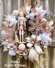 a wreath with a nutcracker and snowflakes on it