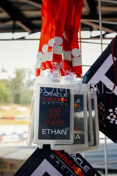 there are some signs hanging from the ceiling in front of other flags and banners on display