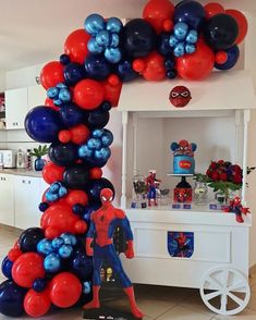 the balloon arch is decorated with red, white and blue balloons for spiderman birthday party