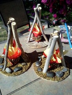 some kind of decoration made out of wood sticks and paper machs on a table