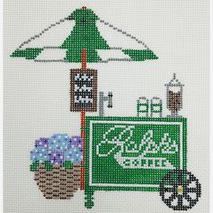 a cross stitch pattern with a green sign