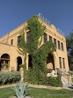 an old building with ivy growing on it's side and the words garage hotel in front