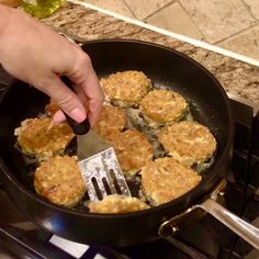 someone is frying some food in a pan on the stove