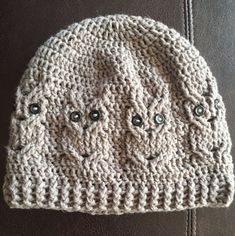 a crocheted hat with two faces on it