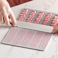 a person is making donuts out of doughnut holes on a sheet of paper