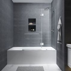 a white bath tub sitting next to a walk in shower