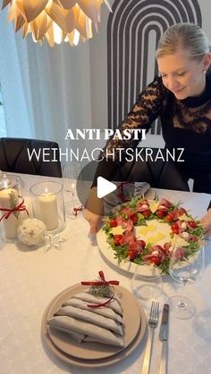 a woman sitting at a table in front of a plate with food on top of it