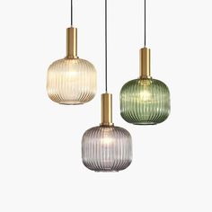 three glass pendant lights hanging from the ceiling