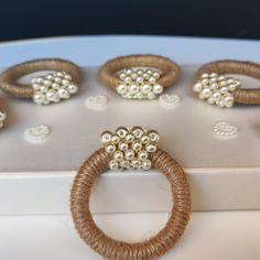 some beads and rings are sitting on a table