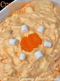 an orange creamsice sauce with marshmallows in the center and on top