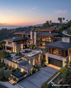 this is an aerial view of a house at dusk with the ocean in the background