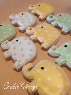 some decorated cookies are sitting on a table with polka dots and an elephant in the middle