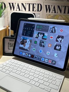 an ipad sitting on top of a desk next to a keyboard