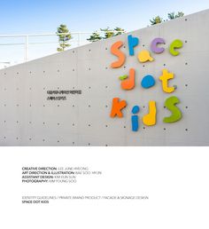 an advertisement for a children's art museum on the side of a wall with colorful letters