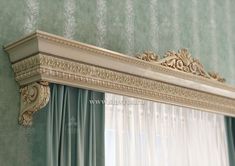 an ornate gold mirror frame with curtains in the background